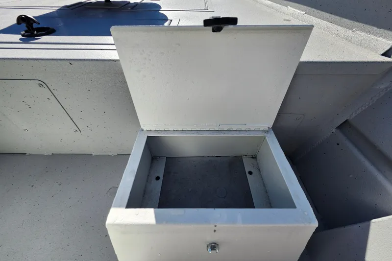 Slide: The Image of Open storage compartment on 2026 Lowe Roughneck 1860CC boat, showcasing interior space. - 16