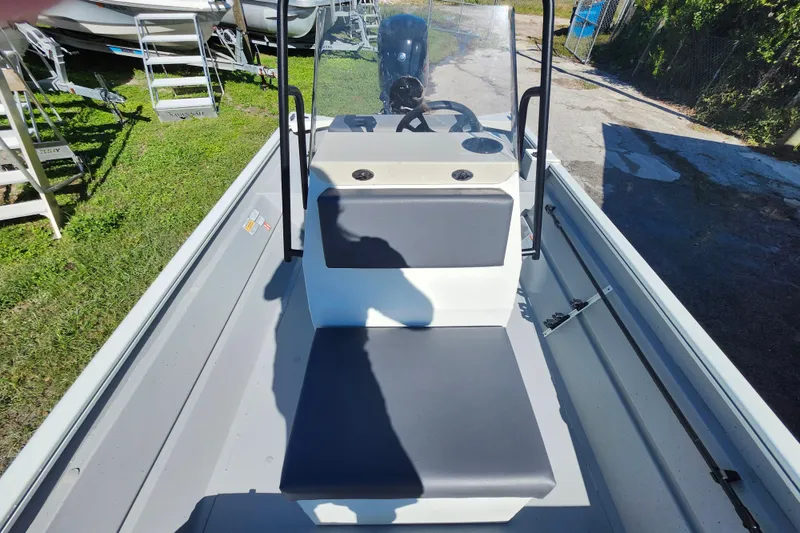 Slide: The Image of 2026 Lowe Roughneck 1860CC boat interior with seating and steering console. - 18