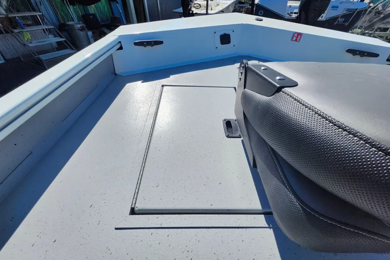 Slide: The Image of 2026 Lowe Roughneck 1860CC boat interior with seating and storage compartment. - 22