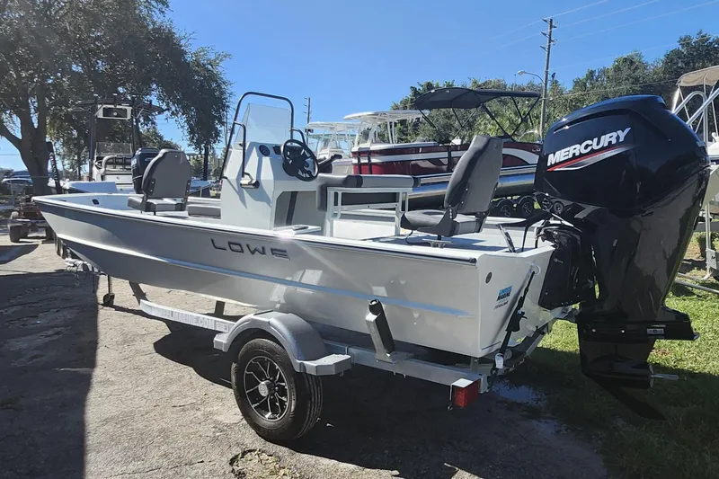 Slide: The Image of 2026 Lowe Roughneck 1860CC boat with Mercury engine on trailer, parked outdoors. - 4