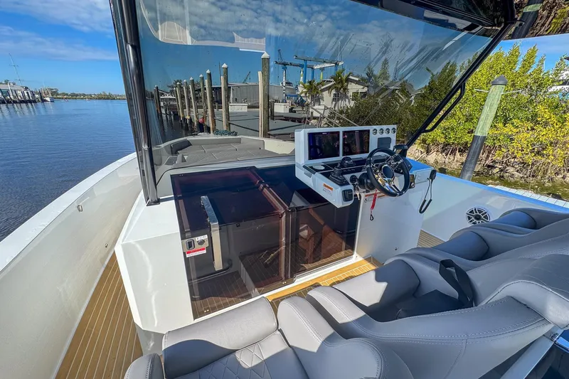 Slide: The Image of 2026 De Antonio Yachts D42 cockpit with modern controls and luxurious seating by the water. - 21