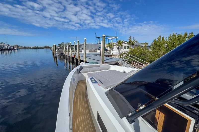 Slide: The Image of 2026 De Antonio Yachts D42 docked, showcasing sleek design and luxurious deck under blue skies. - 42