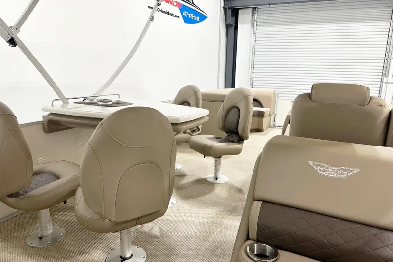 Slide: The Image of 2025 Bennington 23LPDSR boat interior with beige seating and table setup. - 10