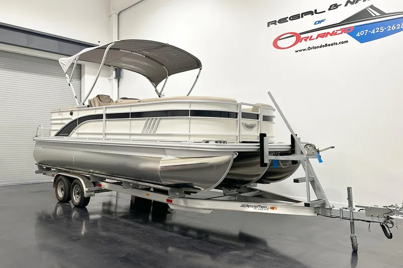 Slide: The Image of 2025 Bennington 23LPDSR pontoon boat on trailer in showroom. - 2