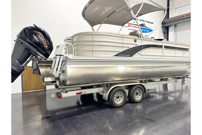 Slide: The Image of 2025 Bennington 23LPDSR pontoon boat on trailer with Yamaha outboard motor. - 3