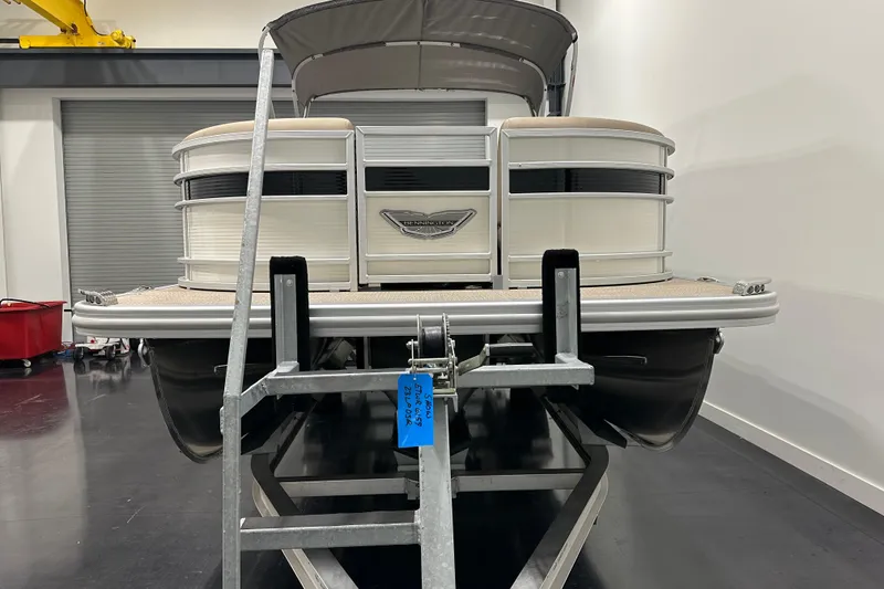 Slide: The Image of 2025 Bennington 23LPDSR pontoon boat on trailer in indoor showroom. - 4