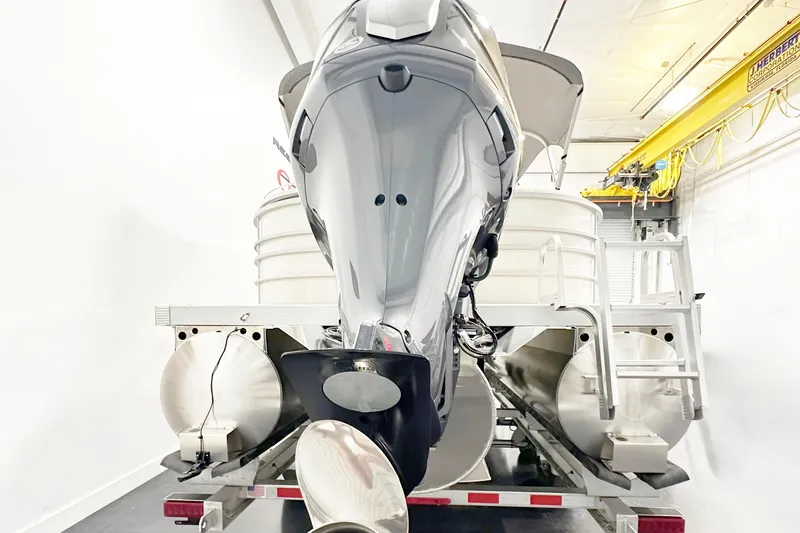 Slide: The Image of 2025 Bennington 23LPDSR pontoon boat in a storage facility, rear view. - 5