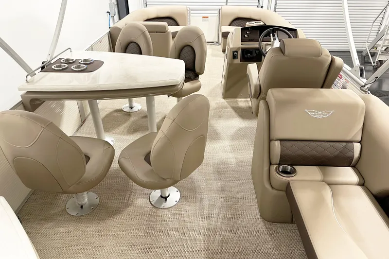 Slide: The Image of Luxurious interior of 2025 Bennington 23LPDSR pontoon boat with beige seating and table. - 6