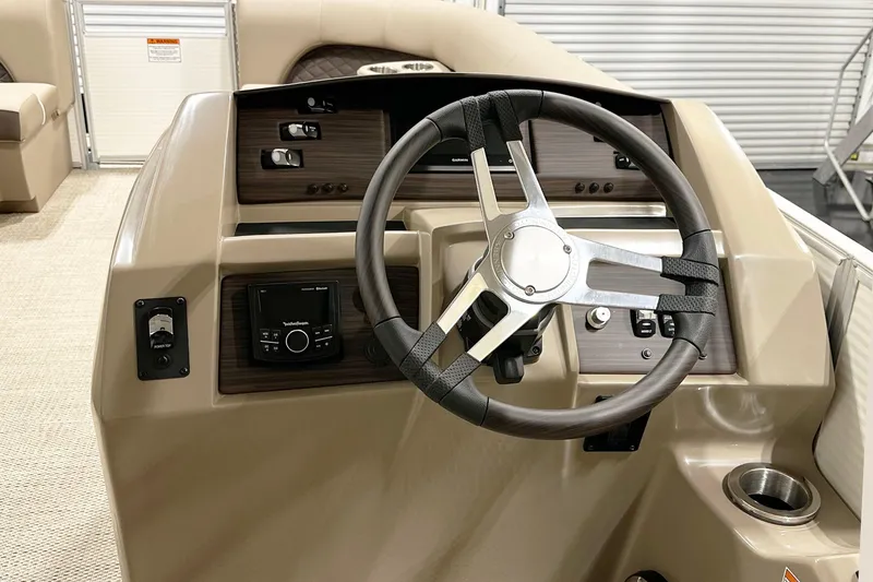 Slide: The Image of 2025 Bennington 23LPDSR boat dashboard with steering wheel and control panel. - 7