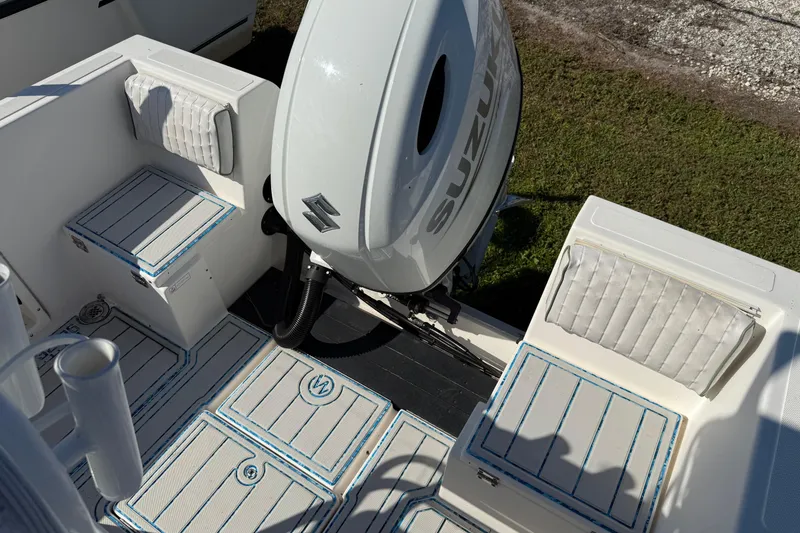 Slide: The Image of 1997 Hydra-Sports 2000 CC boat interior with Suzuki outboard motor, cushioned seating, and storage compartments. - 10
