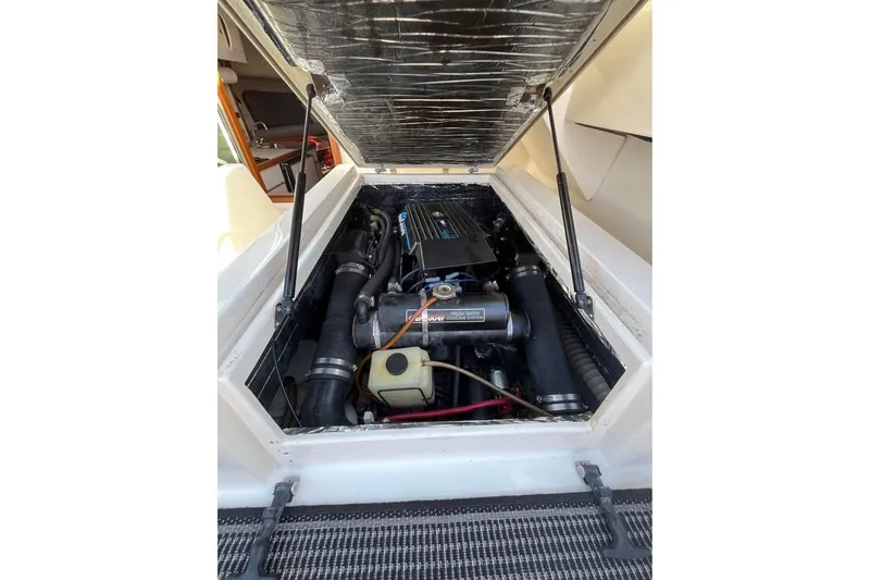 Slide: The Image of 1992 Tiara Yachts 2700 Open engine compartment with visible components and wiring. - 10