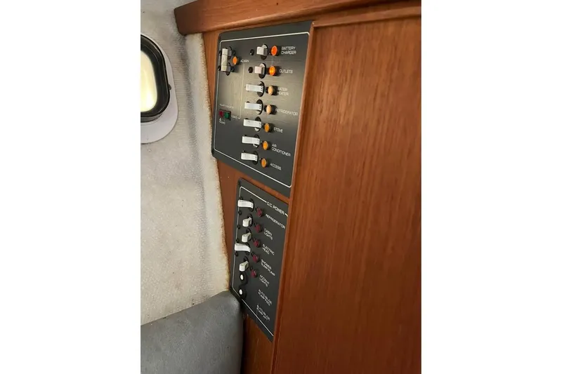 Slide: The Image of Control panel of a 1992 Tiara Yachts 2700 Open, featuring switches and indicators. - 12