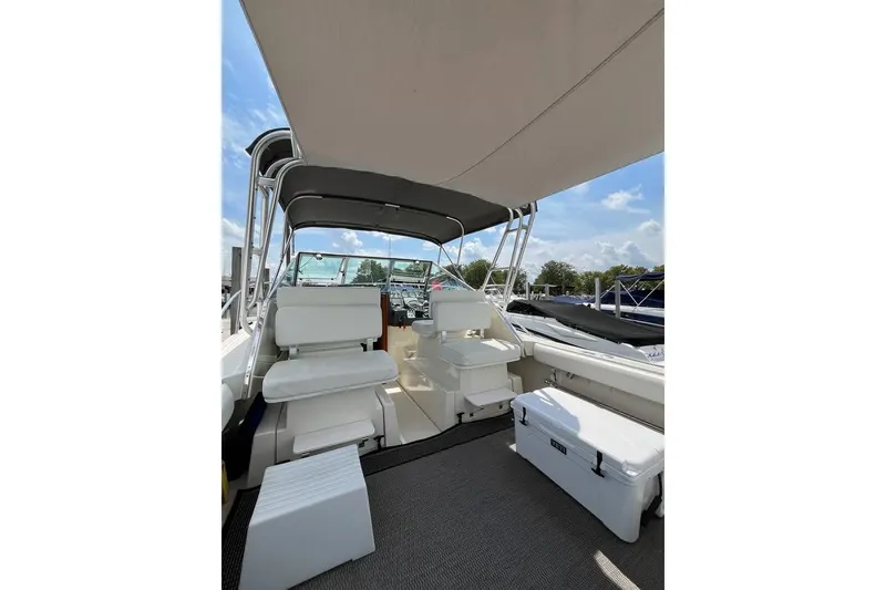Slide: The Image of 1992 Tiara Yachts 2700 Open interior with seating and canopy under blue sky. - 6