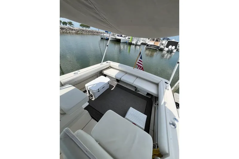Slide: The Image of 1992 Tiara Yachts 2700 Open boat interior with seating, docked at marina. - 7