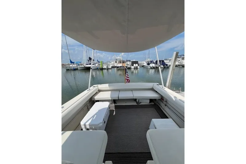 Slide: The Image of 1992 Tiara Yachts 2700 Open boat interior with seating, docked at marina. - 8