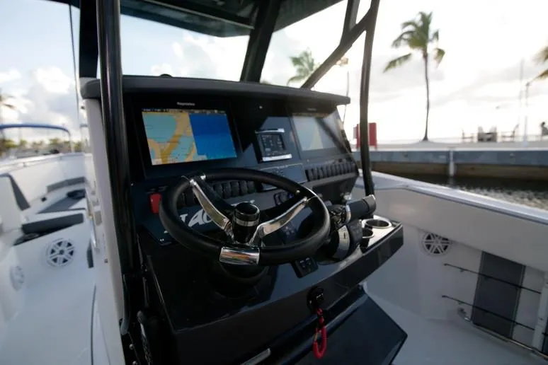 Slide: The Image of 2020 Blackfin 272 CC boat on calm water near a dock with palm trees. - 10