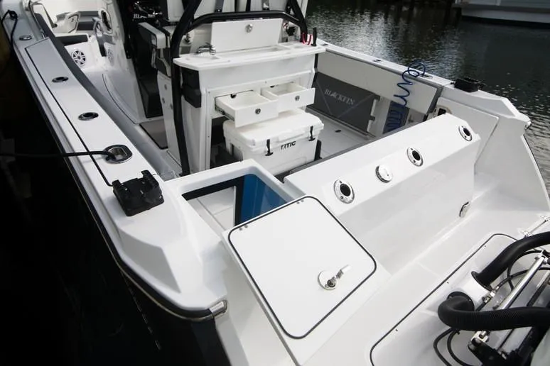 Slide: The Image of 2020 Blackfin 272 CC boat with dual Evinrude engines and seating area. - 15