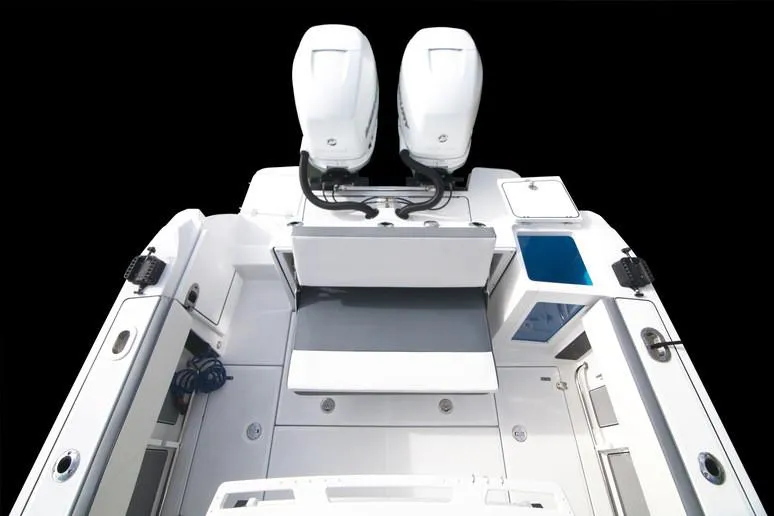 Slide: The Image of 2020 Blackfin 272 CC boat with dual Evinrude engines docked. - 16