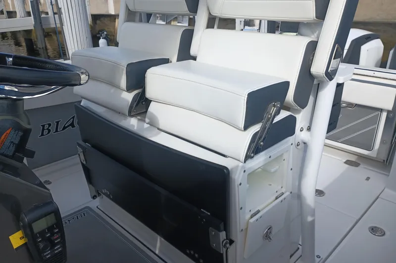 Slide: The Image of 2020 Blackfin 272 CC boat interior with white seating and storage compartments. - 23