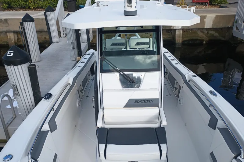 Slide: The Image of 2020 Blackfin 272 CC boat docked, showcasing sleek design and spacious deck. - 26