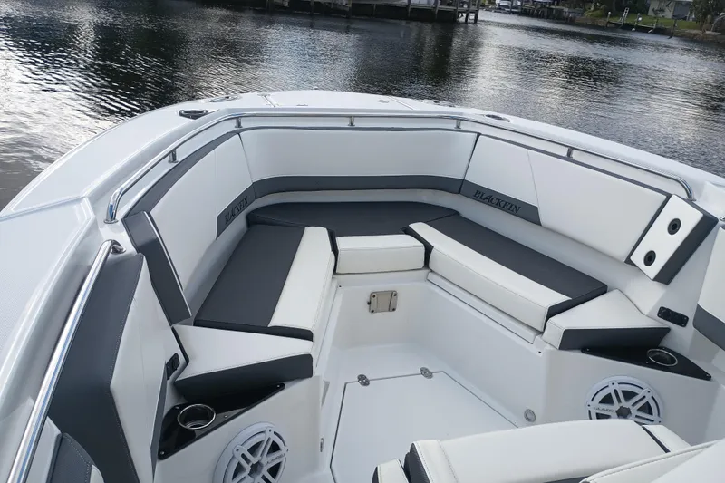 Slide: The Image of 2020 Blackfin 272 CC boat interior with cushioned seating and cup holders. - 27