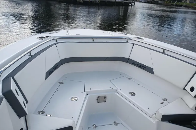 Slide: The Image of 2020 Blackfin 272 CC boat interior with sleek seating and storage compartments. - 32