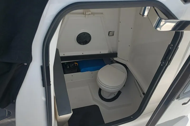 Slide: The Image of 2020 Blackfin 272 CC boat interior with compact marine toilet. - 34