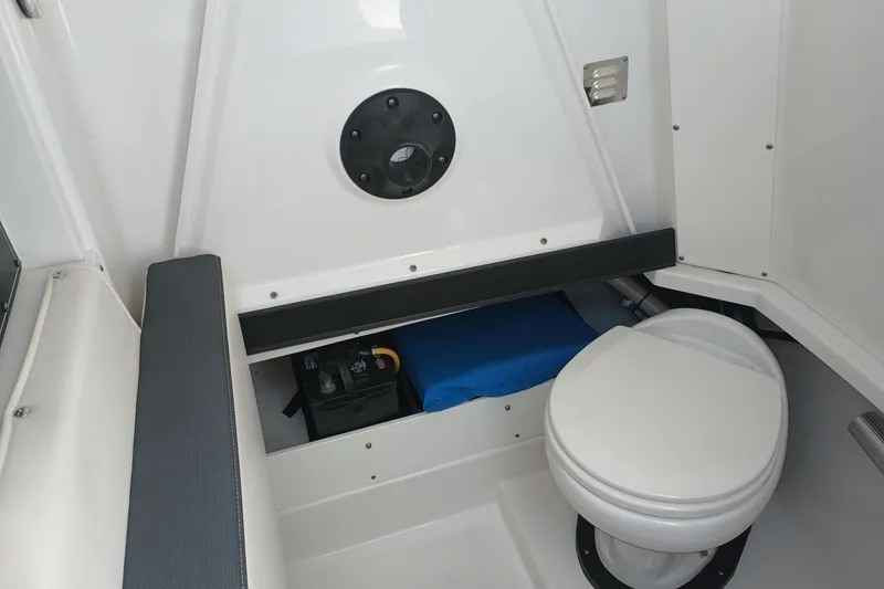 Slide: The Image of 2020 Blackfin 272 CC boat interior with toilet and storage compartment. - 35