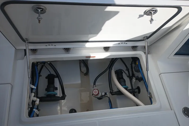 Slide: The Image of 2020 Blackfin 272 CC boat compartment with visible wiring and plumbing. - 39