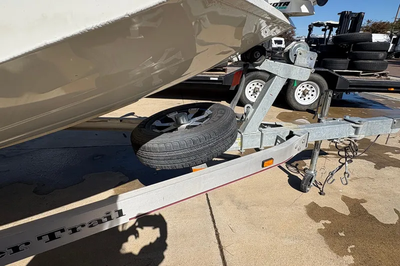 Slide: The Image of 2017 Ranger RB190 Bay boat on trailer with spare tire, parked on concrete. - 11