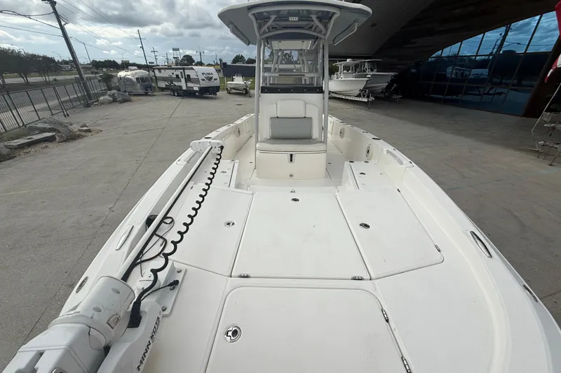 Slide: The Image of 2021 Sea Cat 260 boat with spacious deck and modern design in a marina setting. - 10
