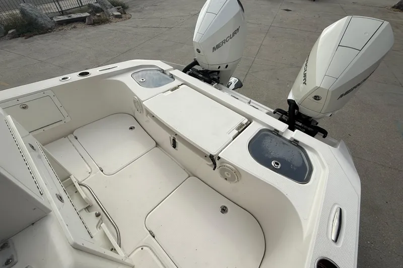 Slide: The Image of 2021 Sea Cat 260 boat with dual Mercury engines, spacious deck, and storage compartments. - 13