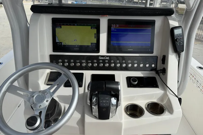 Slide: The Image of Steering console of 2021 Sea Cat 260 boat with navigation screens and controls. - 15