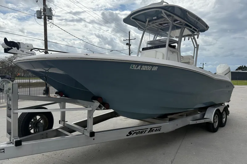 Slide: The Image of 2021 Sea Cat 260 boat on trailer, parked outdoors under cloudy sky. - 4
