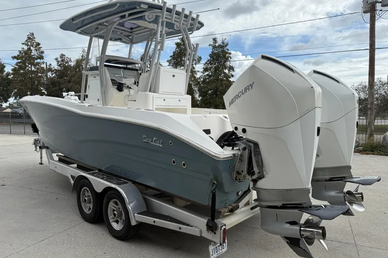 Slide: The Image of 2021 Sea Cat 260 boat with dual Mercury outboard engines on a trailer. - 5