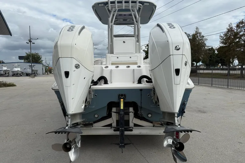 Slide: The Image of 2021 Sea Cat 260 boat with dual outboard engines, parked outdoors. - 6