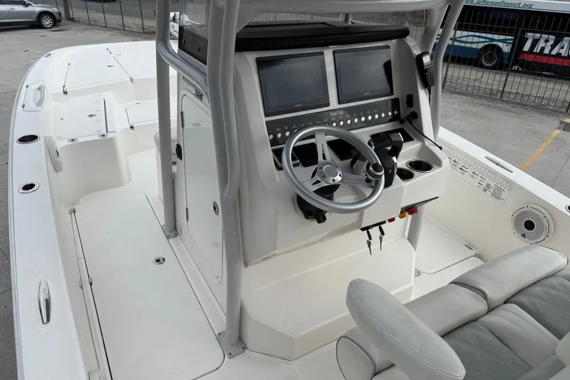 Slide: The Image of 2021 Sea Cat 260 boat interior with dual screens and steering wheel. - 8