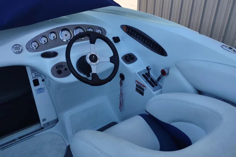 Slide: The Image of 2004 Baja H2X boat cockpit with steering wheel and control panel. - 12