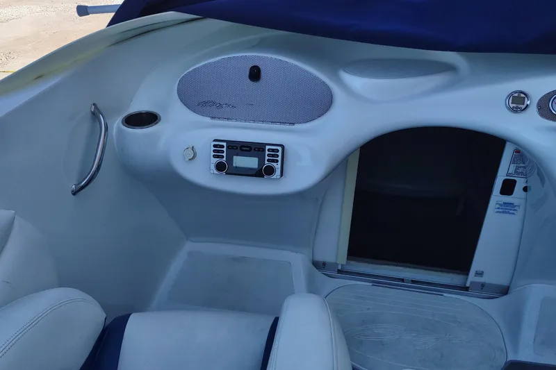Slide: The Image of Interior of a 2004 Baja H2X boat featuring a control panel and seating area. - 13