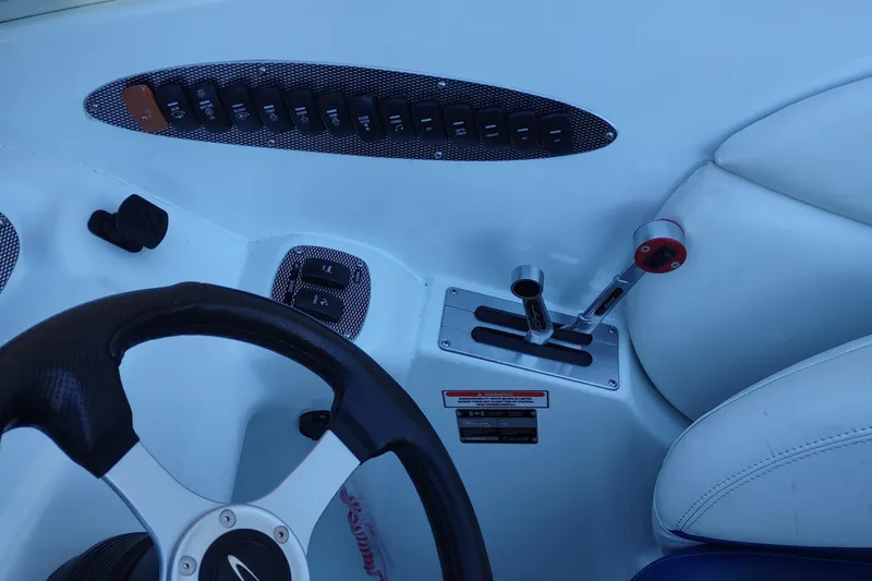 Slide: The Image of 2004 Baja H2X boat cockpit with steering wheel and control panel. - 14