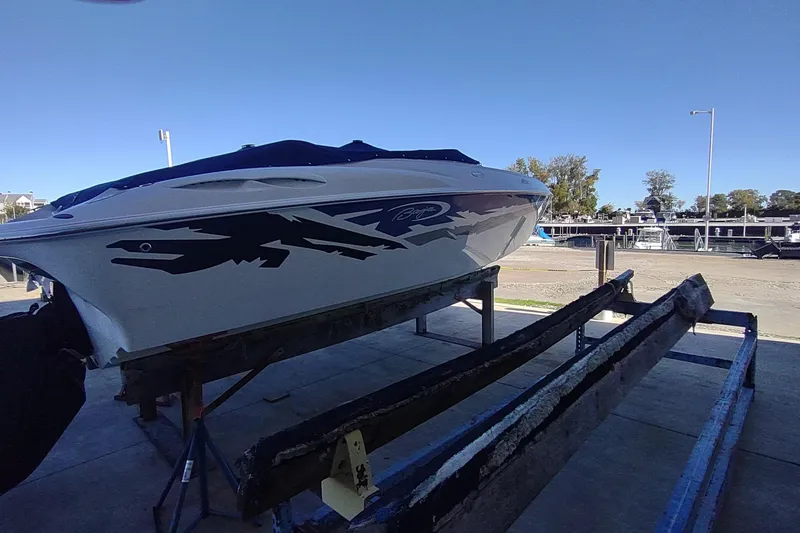 Slide: The Image of 2004 Baja H2X speedboat on trailer, featuring sleek design and bold graphics. - 16