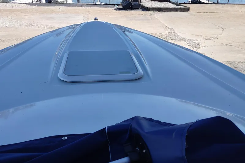 Slide: The Image of 2004 Baja H2X boat deck with hatch, docked on a sunny day. - 19