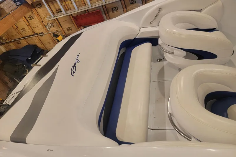 Slide: The Image of 2004 Baja H2X boat interior with white and blue seating in a garage setting. - 23