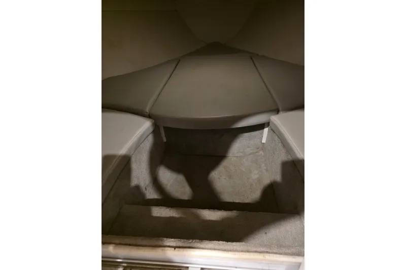 Slide: The Image of Interior cabin of a 2004 Baja H2X boat, featuring cushioned seating. - 24