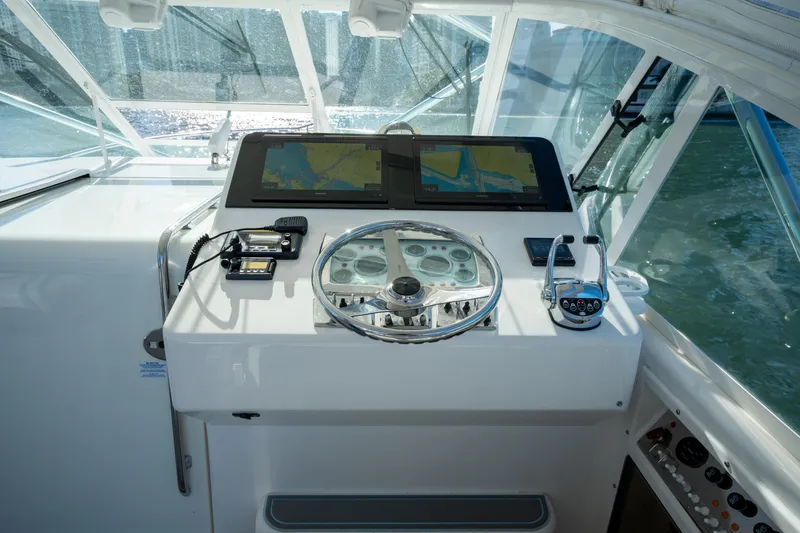 Slide: The Image of Helm of 2004 Cabo 35 Express boat with navigation equipment and steering wheel. - 15