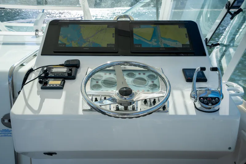 Slide: The Image of Helm of 2004 Cabo 35 Express boat with navigation screens and controls. - 16