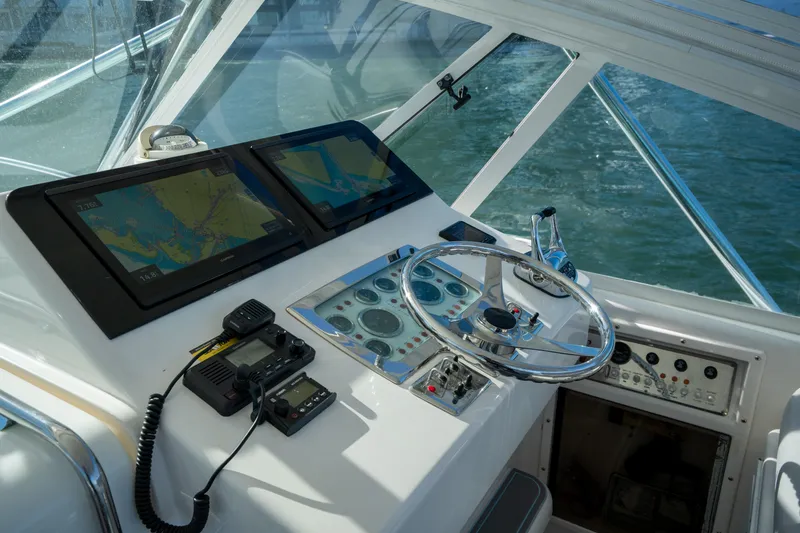 Slide: The Image of Helm of 2004 Cabo 35 Express boat with navigation screens and controls. - 17