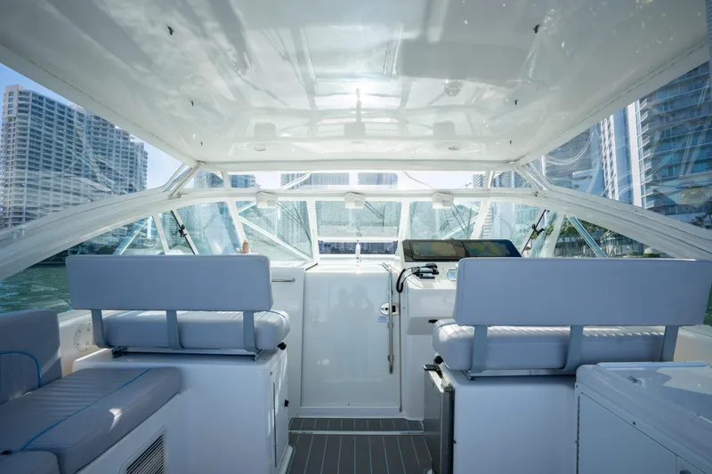 Slide: The Image of 2004 Cabo 35 Express boat interior with modern seating and navigation equipment. - 18