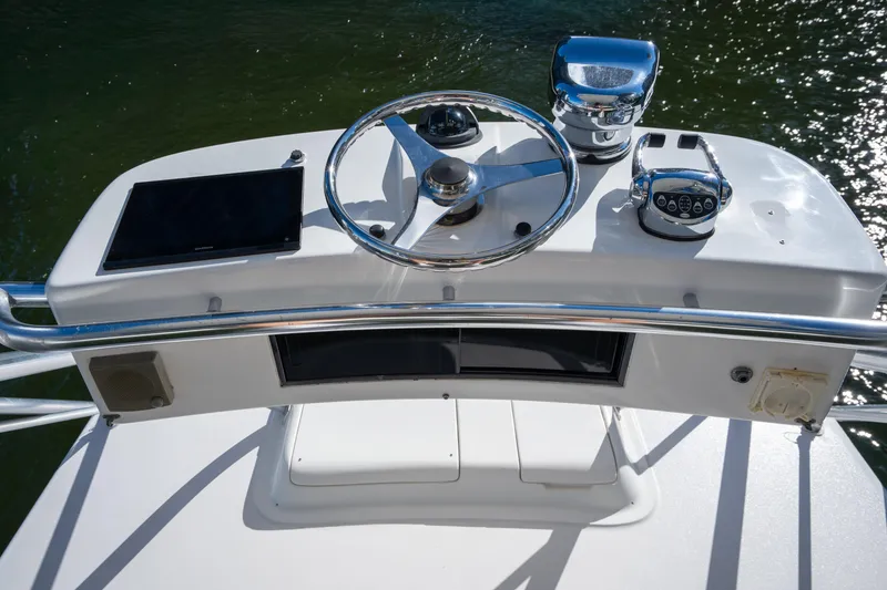 Slide: The Image of Helm of 2004 Cabo 35 Express boat with steering wheel and controls. - 19
