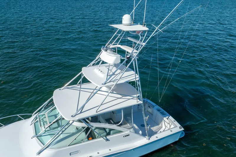 Slide: The Image of 2004 Cabo 35 Express boat with tower on blue ocean water. - 2